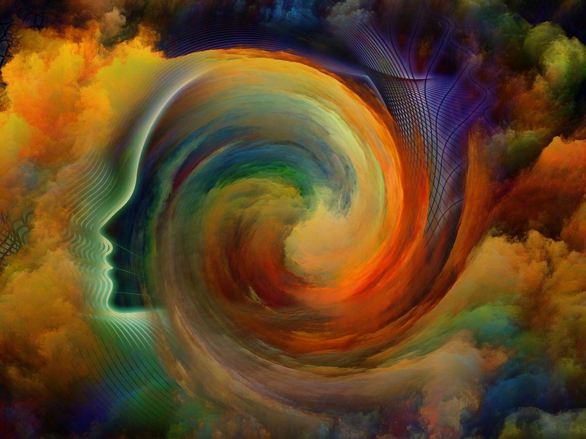 Artistic profile of a face beside a swirling rainbow of color, representing the chakra system